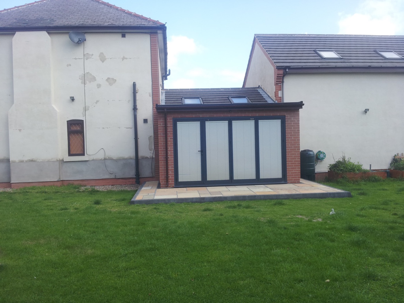 Single-storey brick rear extension with roof windows and bi-fold doors